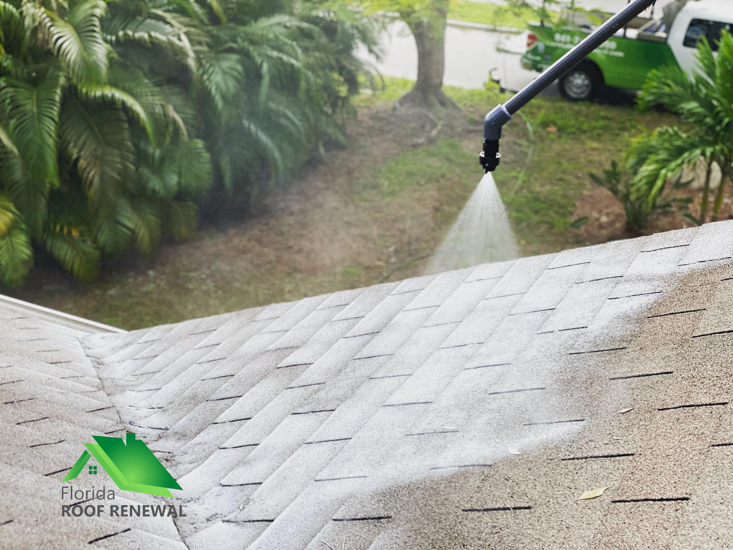 Wide angle view of crew applying acrylic coating on residential roof